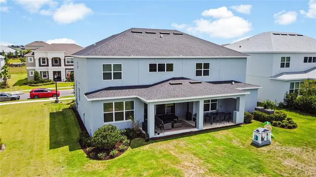 an aerial view of residential houses with outdoor space and swimming pool