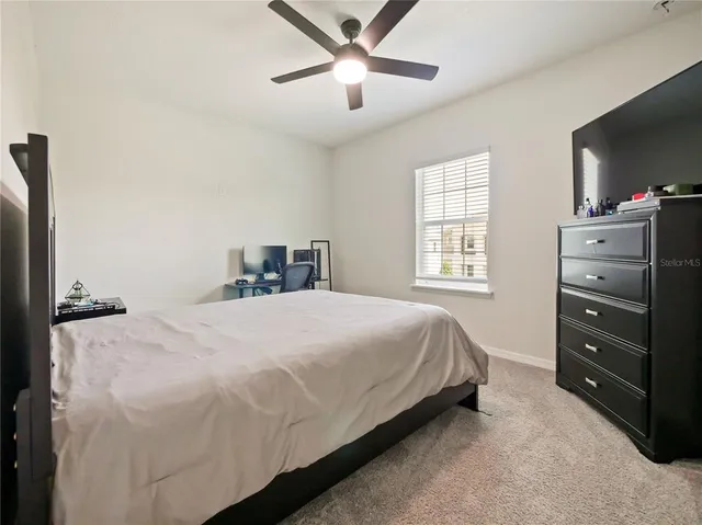 a living room with furniture a mirror and a lamp