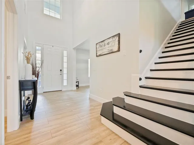 a living room with furniture a flat screen tv and a table