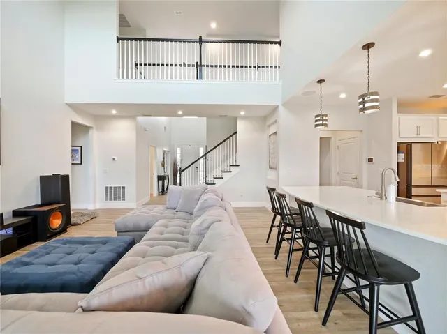 a view of a hallway with wooden floor and a bathroom