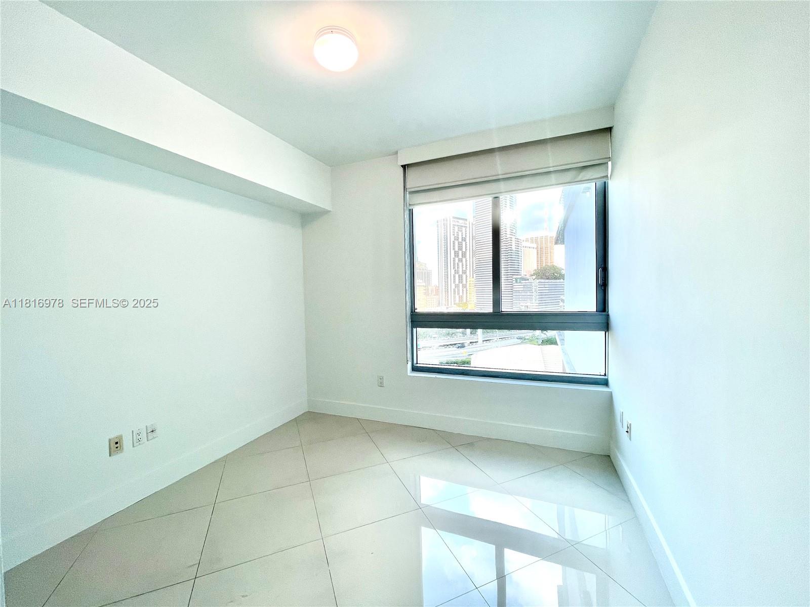 350 South Miami Avenue, Unit 1103 Miami, FL 33130 - Photo 24 of 32 a view of an empty room with a window