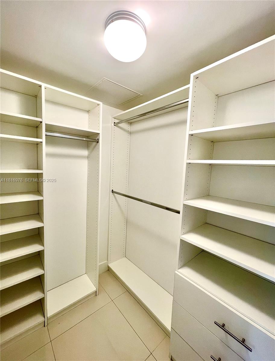 350 South Miami Avenue, Unit 1103 Miami, FL 33130 - Photo 27 of 32 a view of walk in closet with empty racks