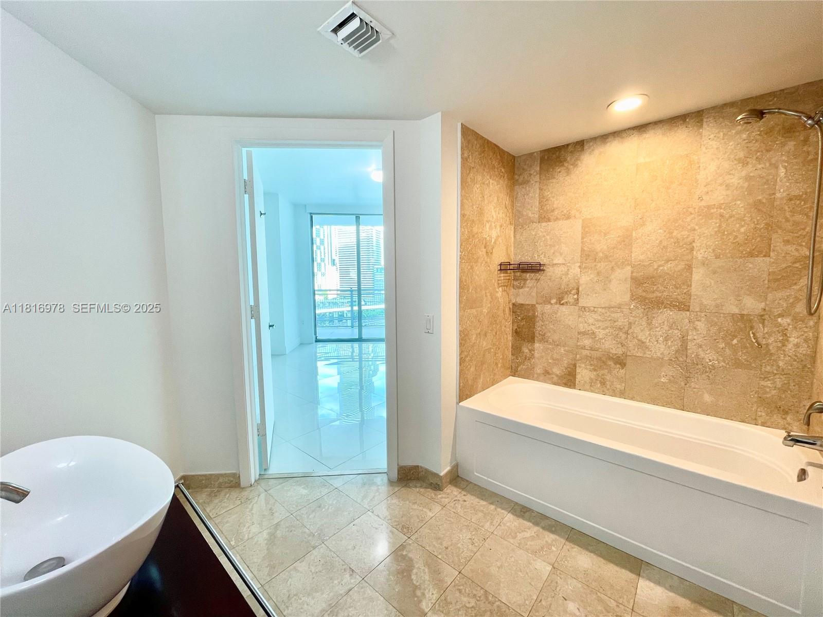 350 South Miami Avenue, Unit 1103 Miami, FL 33130 - Photo 29 of 32 a bathroom with a bathtub and a sink