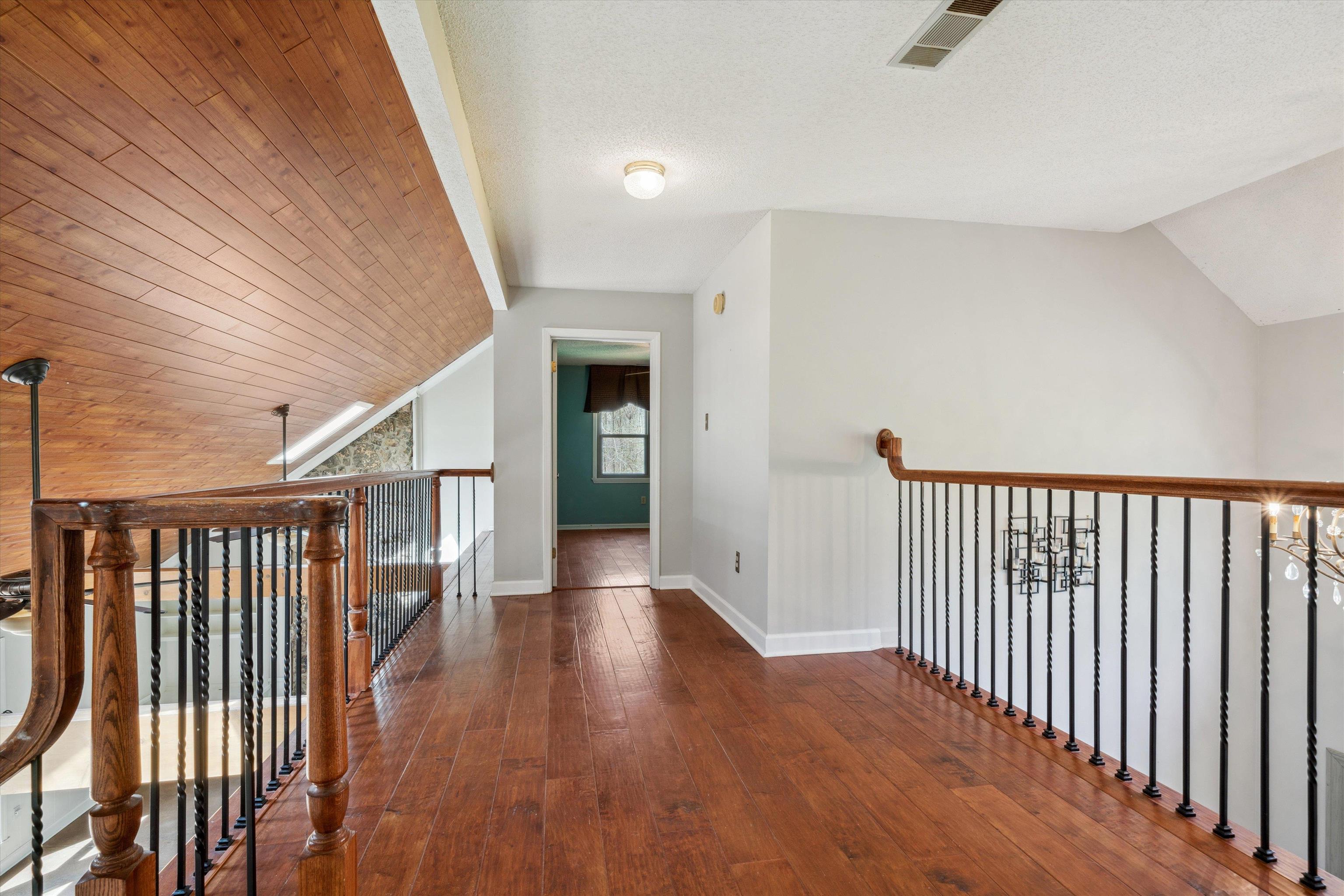 745 Sylvan Road Millington, TN 38053 - Photo 18 of 40 Hallway featuring hardwood / wood-style flooring, lofted ceiling, and baseboards