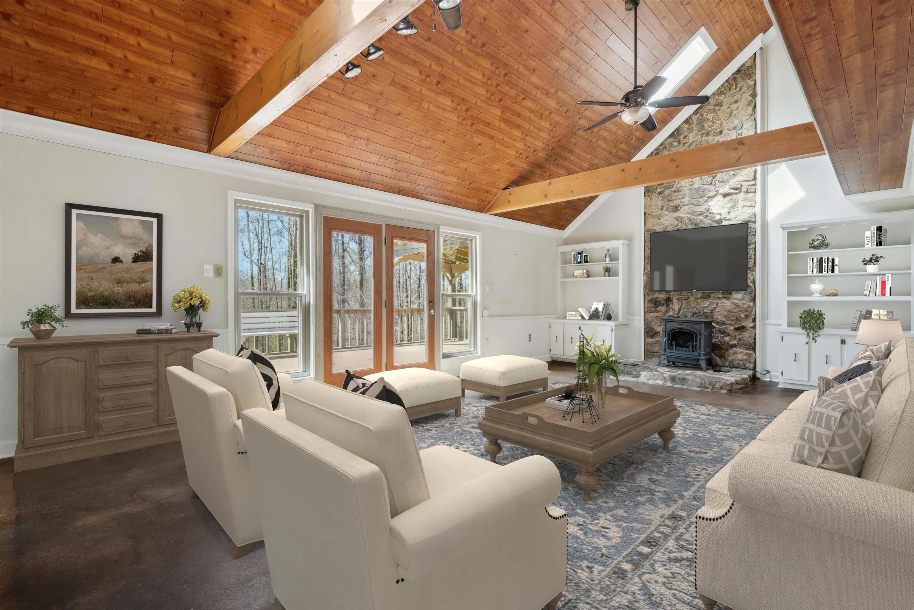 745 Sylvan Road Millington, TN 38053 - Photo 6 of 40 Living room with wood ceiling, built in shelves, a wood stove, ceiling fan, and track lighting