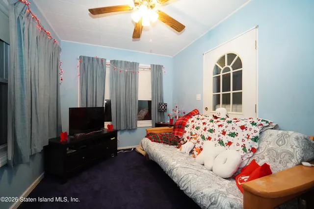 a bedroom with furniture and a flat screen tv