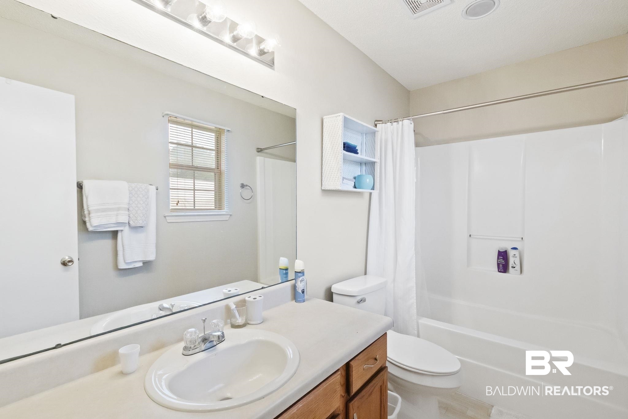 14031 Brook Hollow Road Summerdale, AL 36580 - Photo 29 of 56 Full bathroom with shower / bathtub combination with curtain, vanity, and toilet
