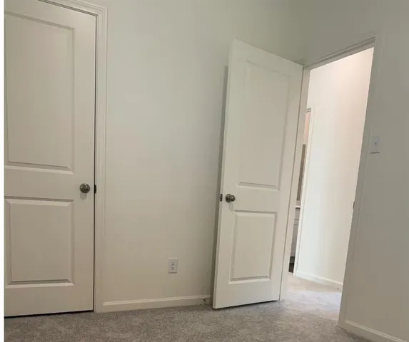 an empty room with closet area