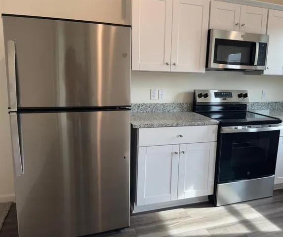 a white refrigerator freezer sitting in a kitchen