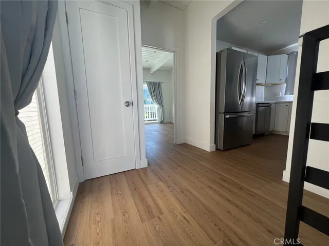 a view of a kitchen from a hallway