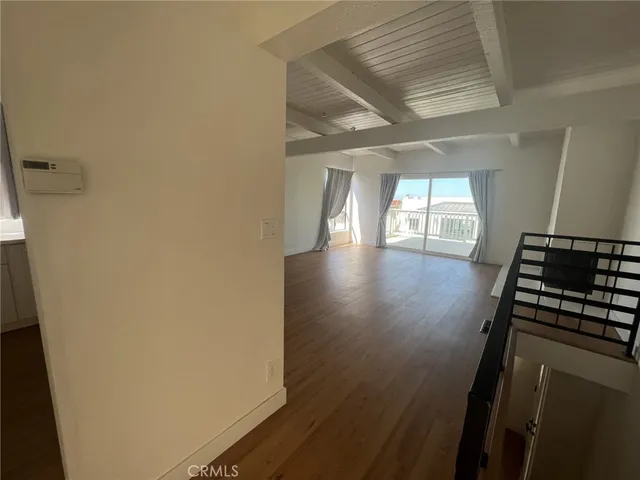 a hallway with wooden floor windows and slide