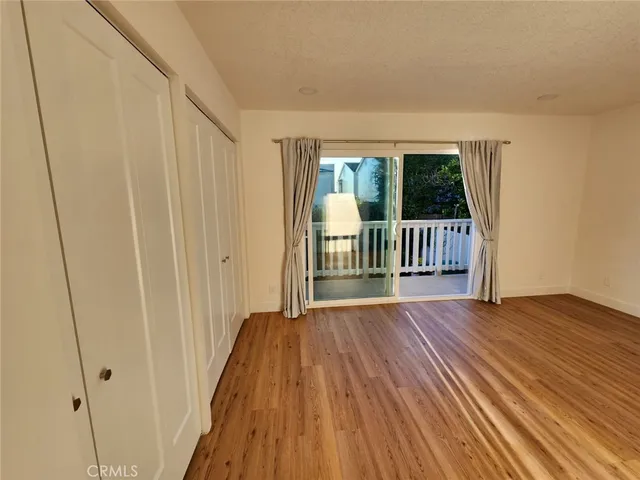 a view of a porch with wooden floor and fence