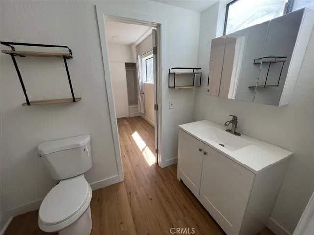 a spacious bathroom with a toilet sink and mirror