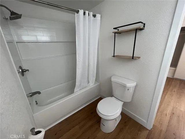 a bathroom with a toilet and a shower