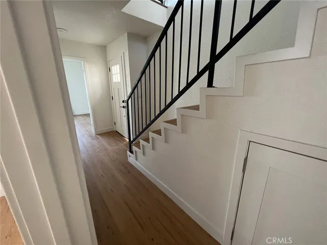 a view of entryway and hall with wooden floor