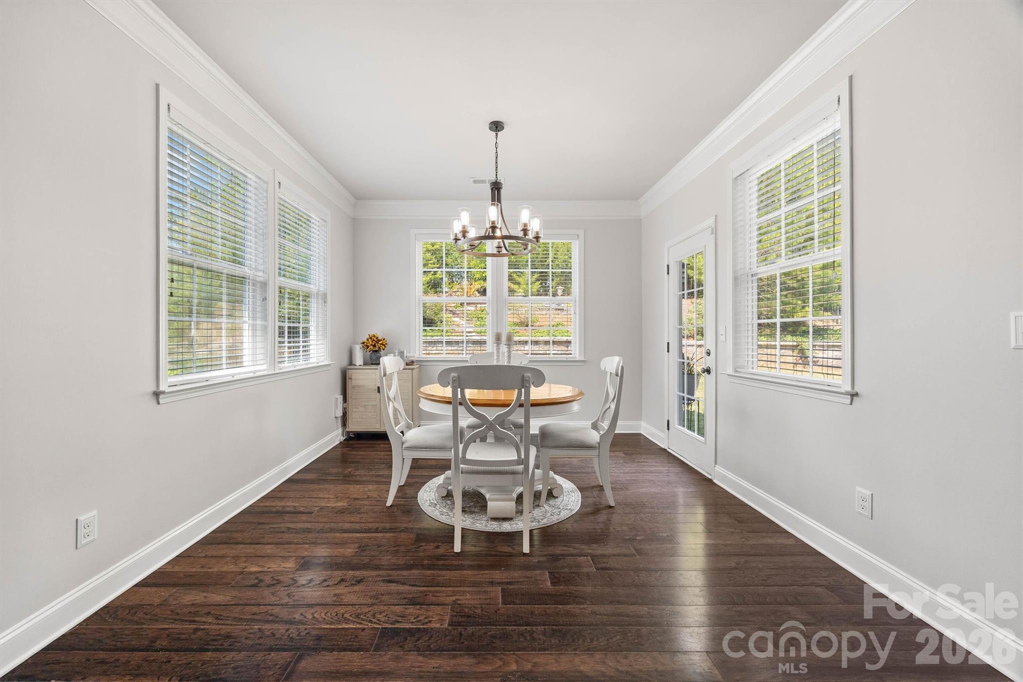 299 Annatto Way Tega Cay, SC 29708 - Photo 13 of 46 a dining room with furniture a chandelier and wooden floor
