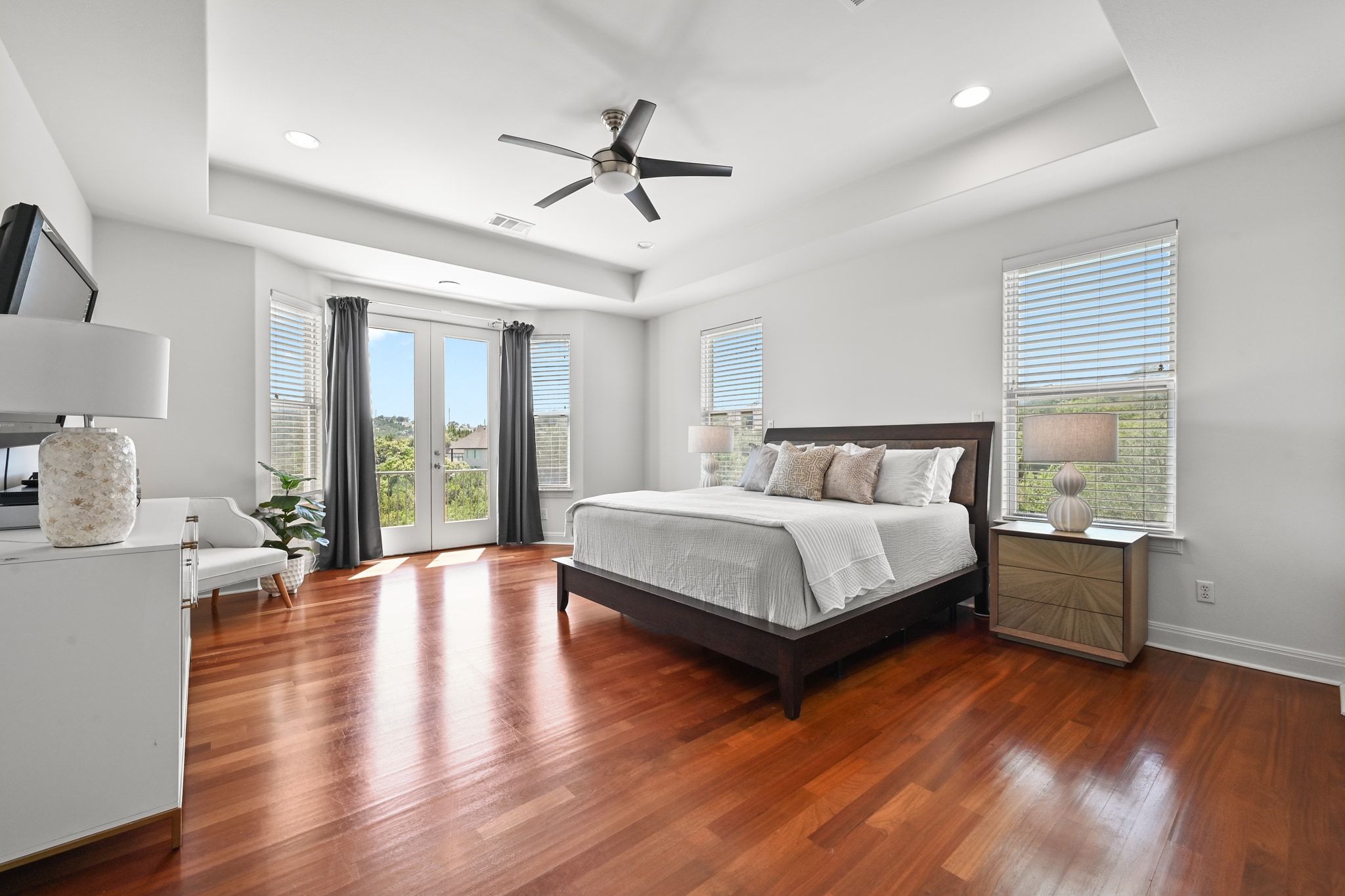 405 Barrett Lane Austin, TX 78733 - Photo 12 of 39 a bedroom with a bed and wooden floor