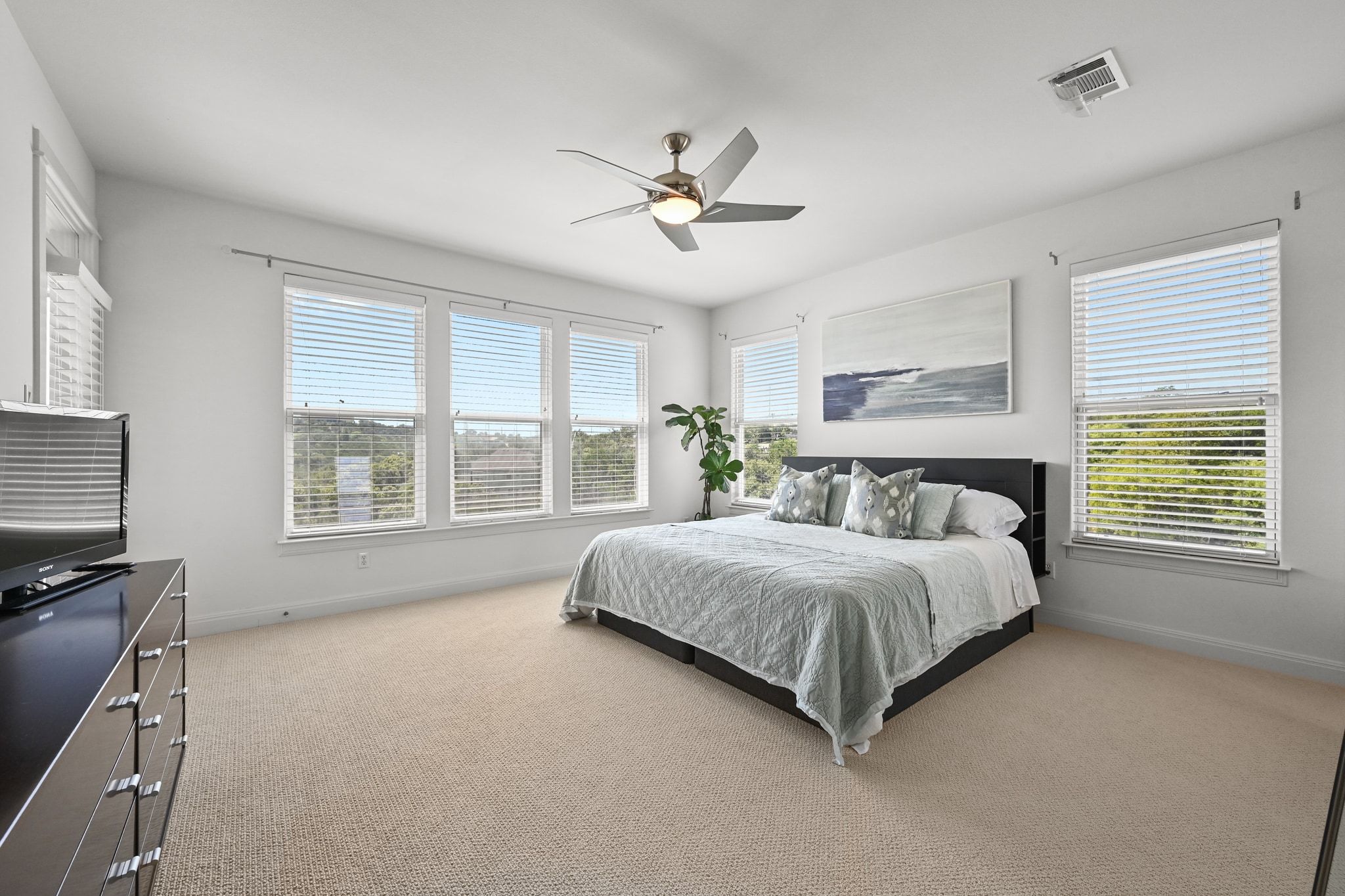 405 Barrett Lane Austin, TX 78733 - Photo 19 of 37 a spacious bedroom with a large bed and a chandelier