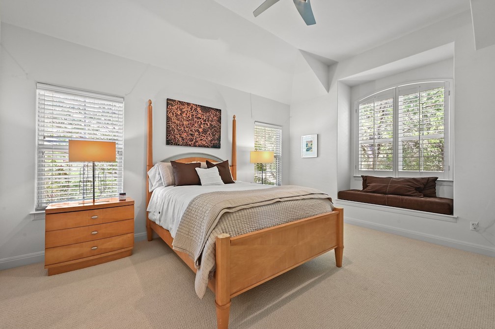 405 Barrett Lane Austin, TX 78733 - Photo 21 of 39 a bedroom with a bed and window