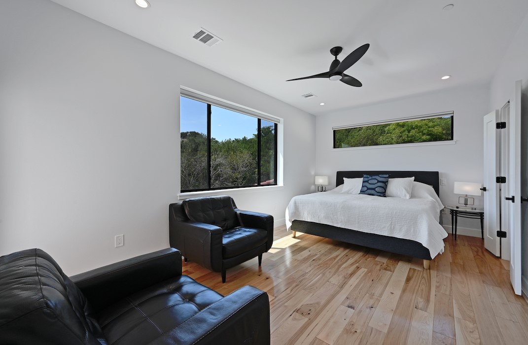 405 Barrett Lane Austin, TX 78733 - Photo 31 of 37 a bedroom with a bed and wooden floor