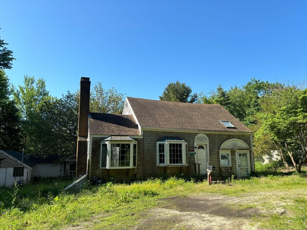 693 Orleans Road North Chatham, MA 02650 - Photo 1 of 41 a front view of a house with a yard