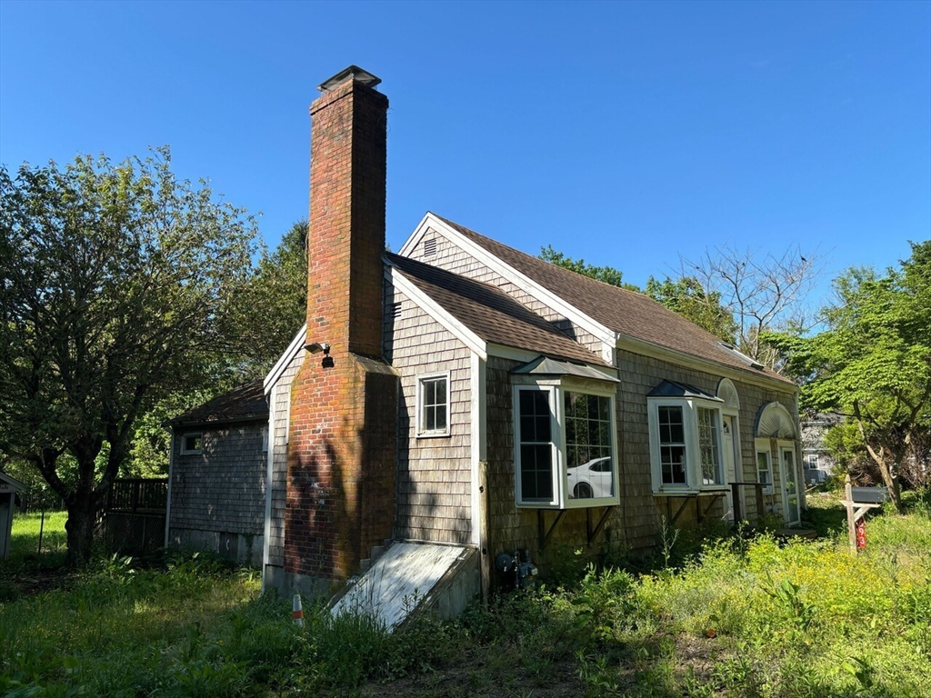 693 Orleans Road North Chatham, MA 02650 - Photo 14 of 41 a front view of a house with garden