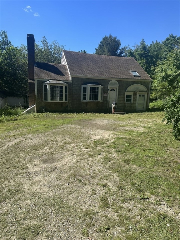 693 Orleans Road North Chatham, MA 02650 - Photo 8 of 41 a front view of a house with a garden