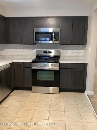 a kitchen with a cabinets and a stove top oven