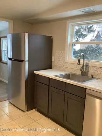a kitchen with a refrigerator and a sink