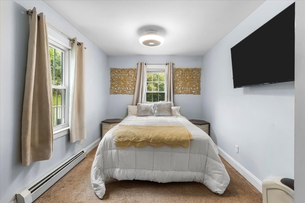 20 Cooks Lane Bellingham, MA 02019 - Photo 11 of 21 a bedroom with a bed and a flat tv screen on the dresser