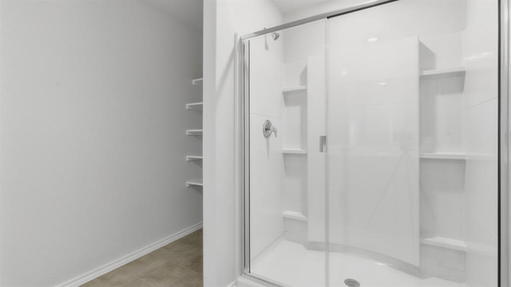 169 MLM Parkway Bridgeport, TX 76426 - Photo 9 of 21 a bathroom with a glass shower door