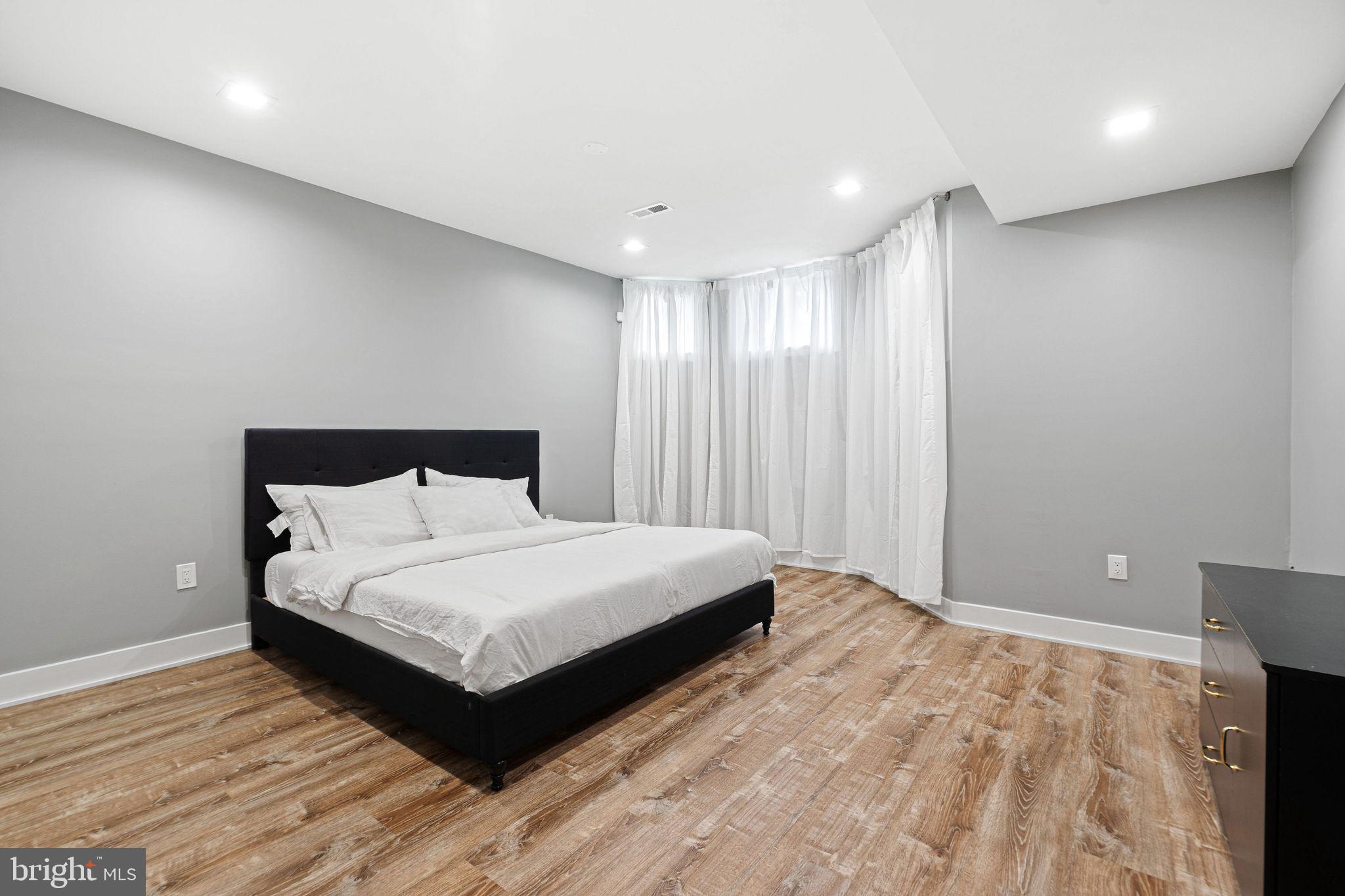 1224 Norwalk Road Philadelphia, PA 19115 - Photo 18 of 47 a bedroom with a large bed and a chandelier