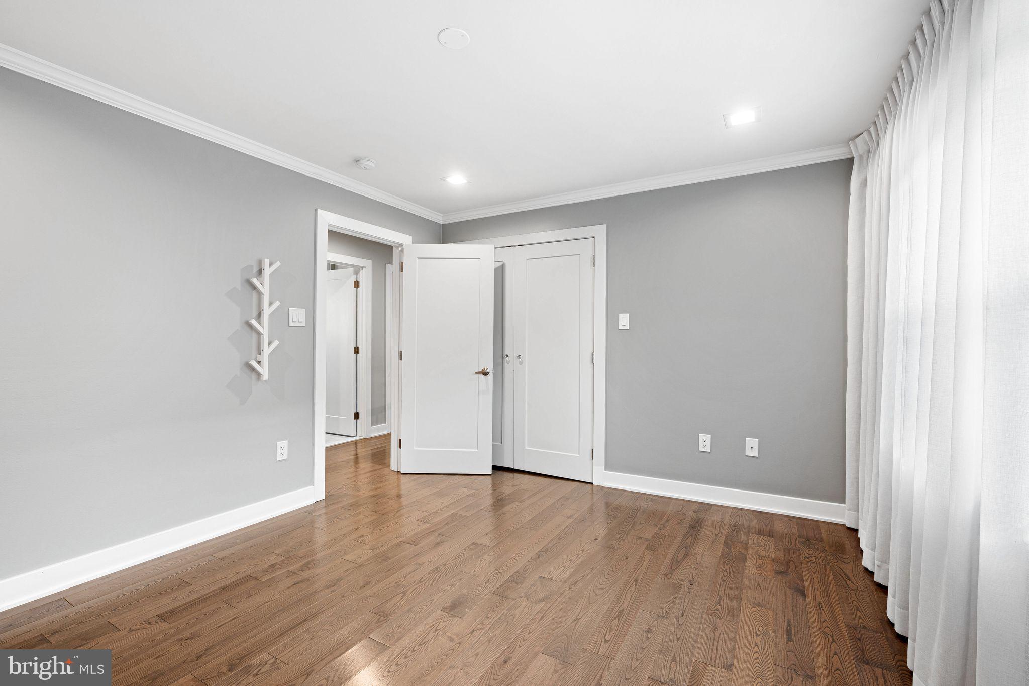 1224 Norwalk Road Philadelphia, PA 19115 - Photo 20 of 47 a view of an empty room with wooden floor and a window