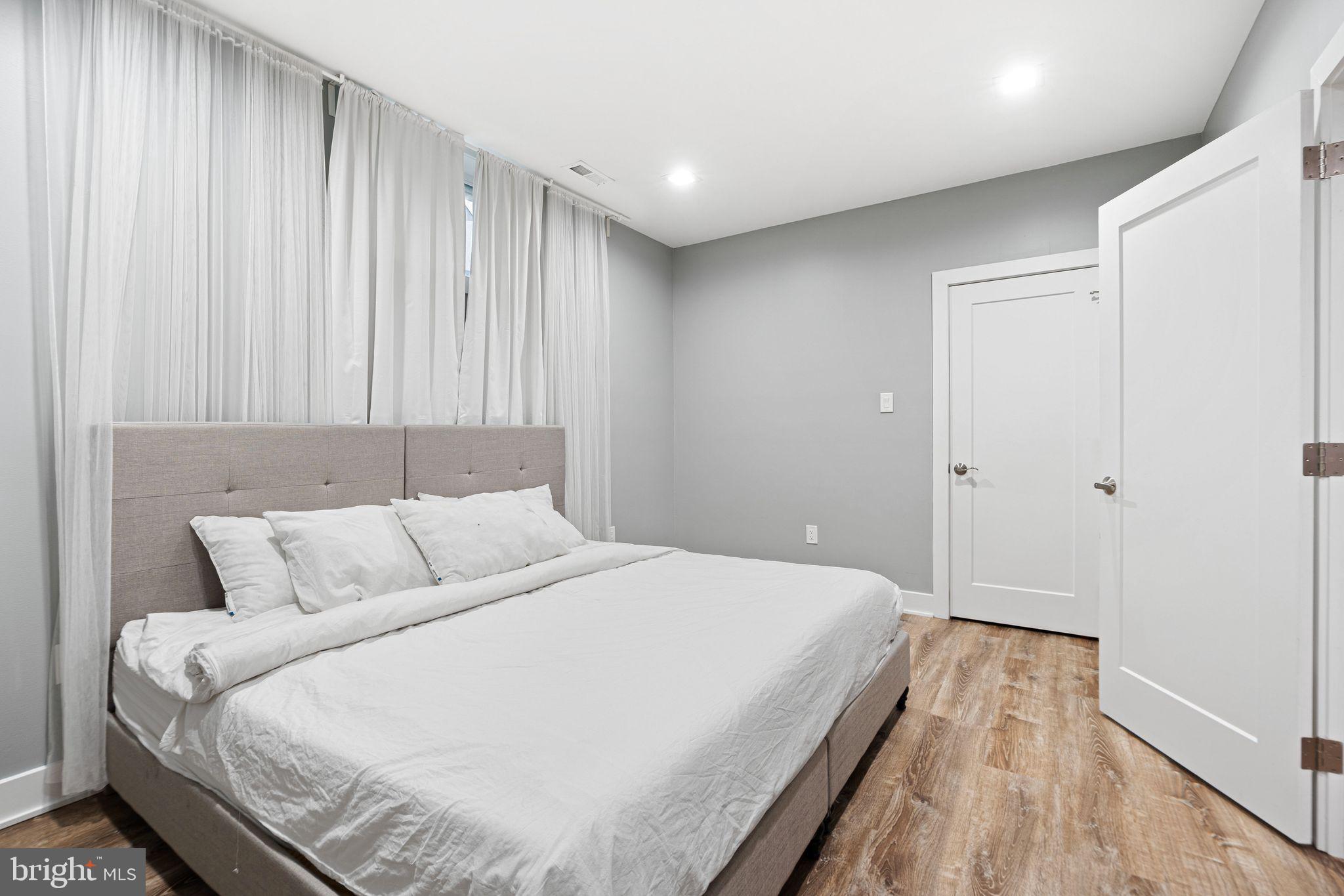 1224 Norwalk Road Philadelphia, PA 19115 - Photo 21 of 47 a bedroom with a bed and a wooden floor