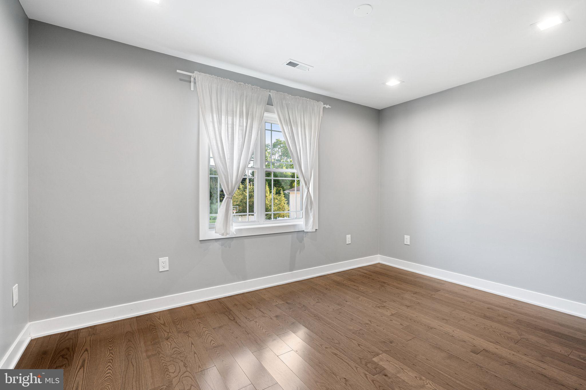 1224 Norwalk Road Philadelphia, PA 19115 - Photo 27 of 47 a view of an empty room with wooden floor and a window