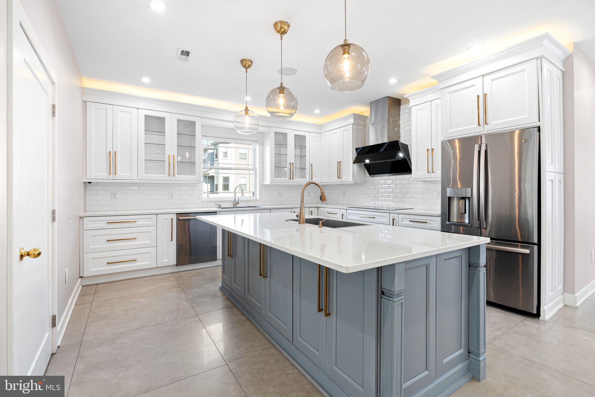 1224 Norwalk Road Philadelphia, PA 19115 - Photo 6 of 47 a kitchen with stainless steel appliances a sink stove and refrigerator