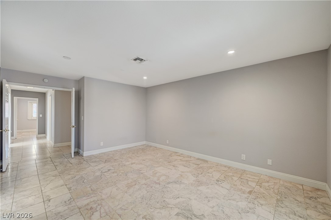 6635 Costa Brava Road Las Vegas, NV 89146 - Photo 28 of 59 Recessed lighting illuminates this versatile room, featuring elegant tile flooring and ample open space.