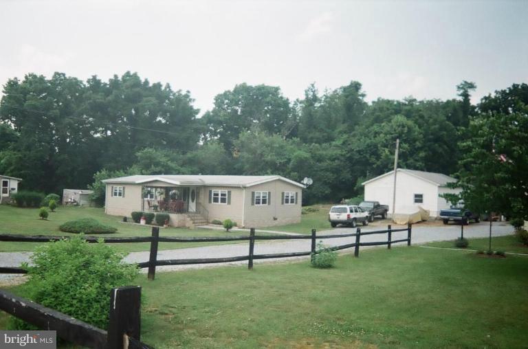 2191 Lewisville Road Summit Point, WV 25446 - Photo 1 of 18 a aerial view of a house with backyard and trees