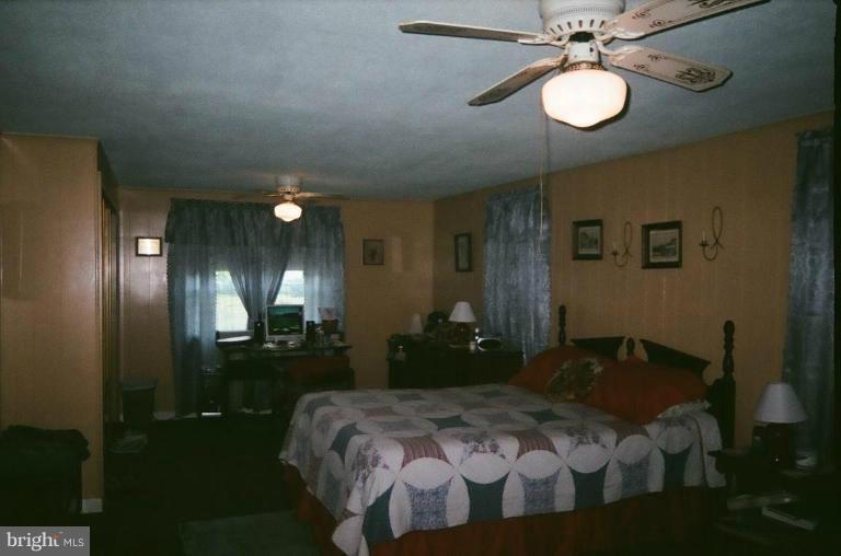 2191 Lewisville Road Summit Point, WV 25446 - Photo 12 of 18 a bedroom with a bed and chandelier