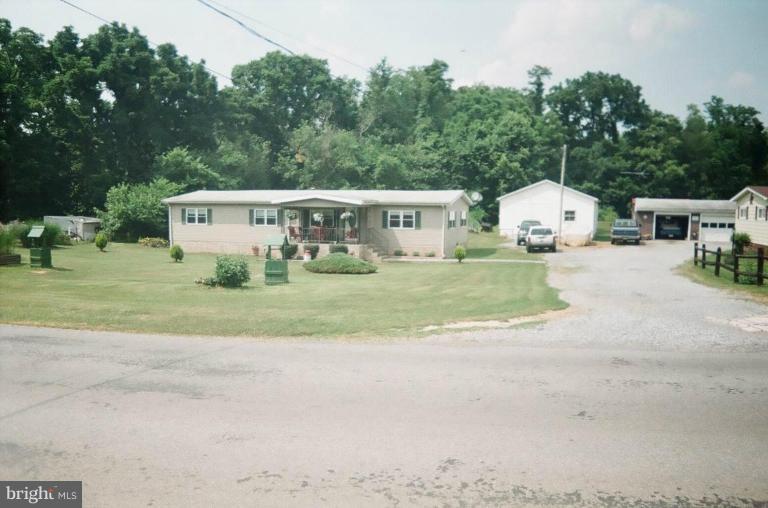 2191 Lewisville Road Summit Point, WV 25446 - Photo 6 of 18 a view of a house with backyard and trees