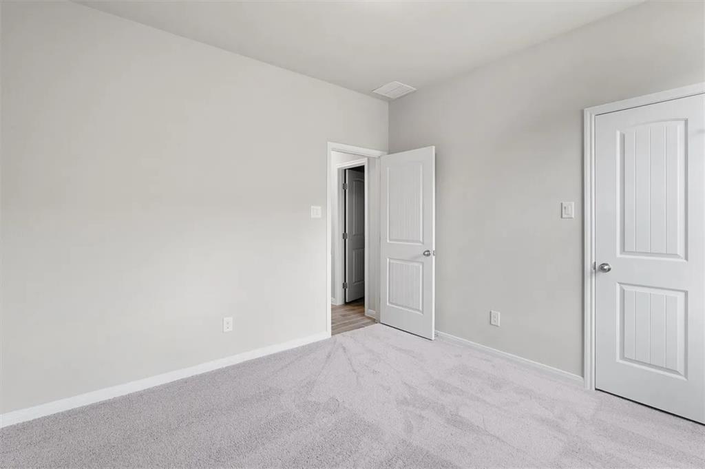 332 Stellar Wind Drive Georgetown, TX 78628 - Photo 19 of 29 A spacious, naturally illuminated room featuring plush carpet flooring, ready for your personal touch.