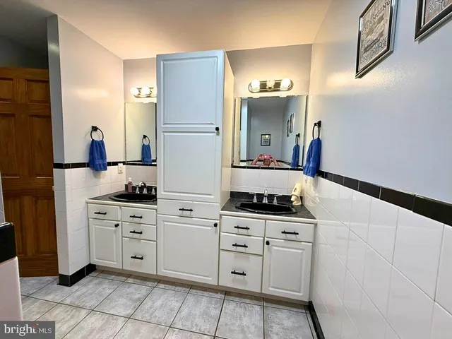 a bedroom with furniture and a flat tv screen