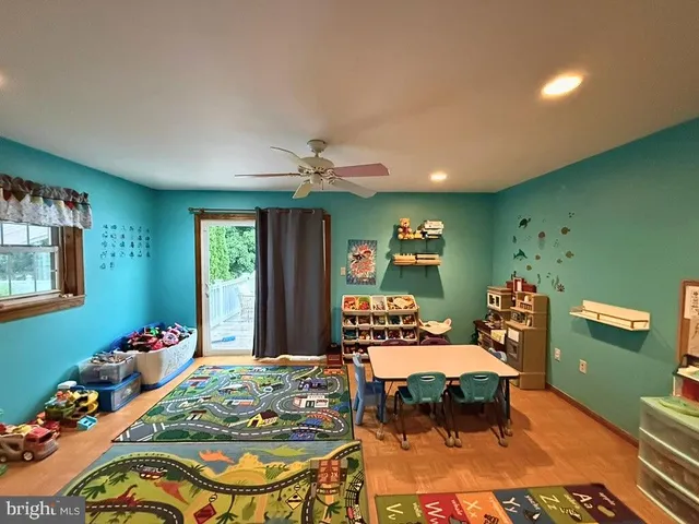 a bedroom with a bed and large windows