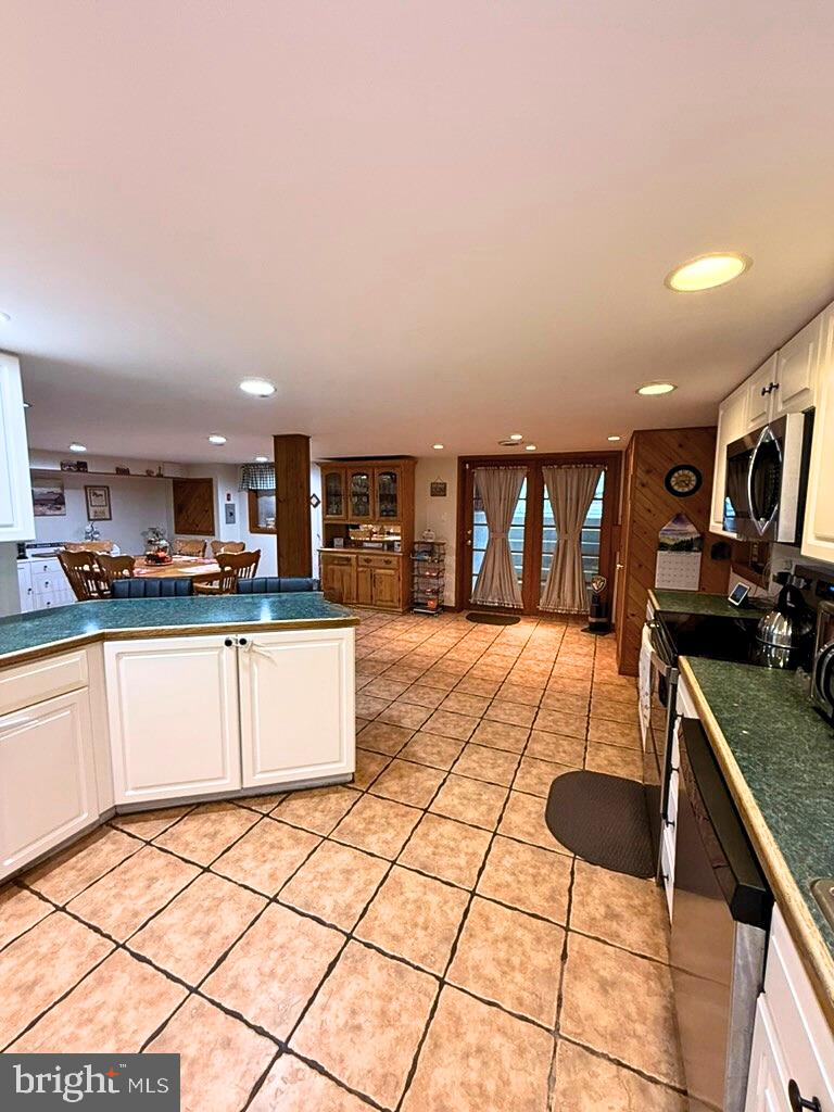 31569 Jim Davis Road Galena, MD 21635 - Photo 34 of 42 a kitchen with stainless steel appliances kitchen island granite countertop a sink and cabinets