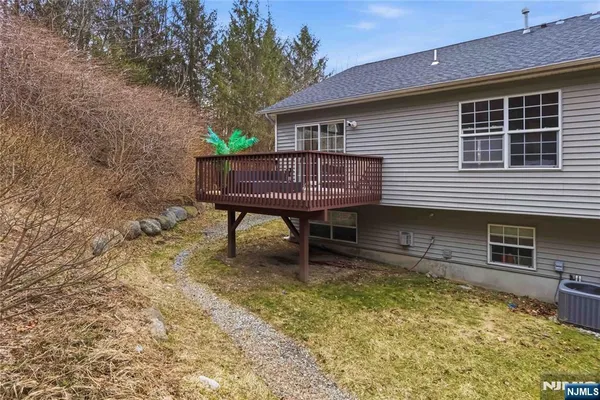 a backyard of a house with table and chairs