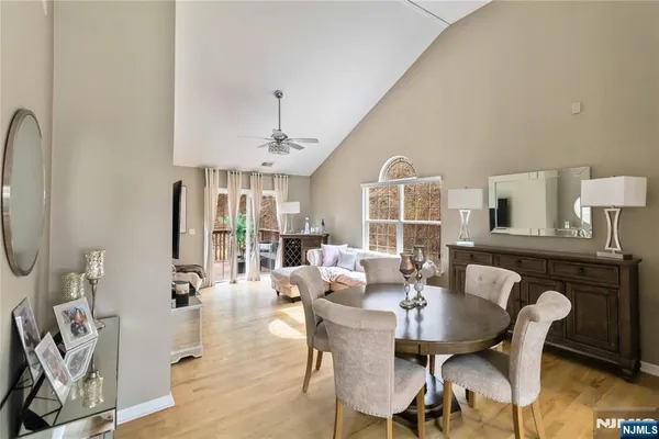 a view of a a dining room with furniture window and wooden floor