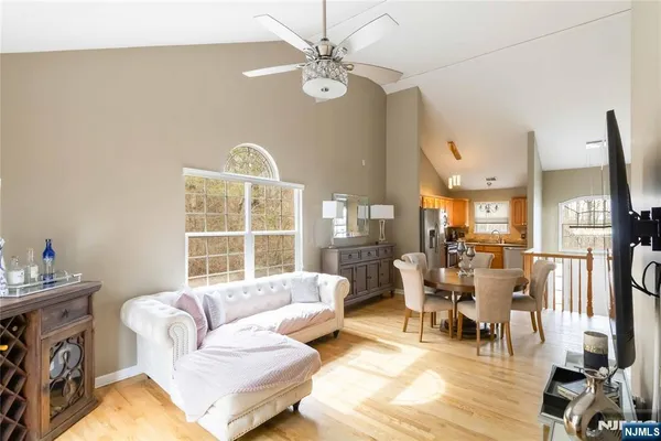 a living room with furniture a flat screen tv and a large window
