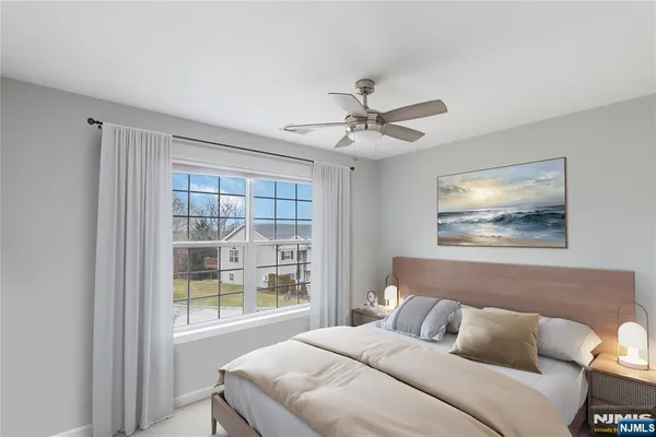 a bedroom with a large bed and a window