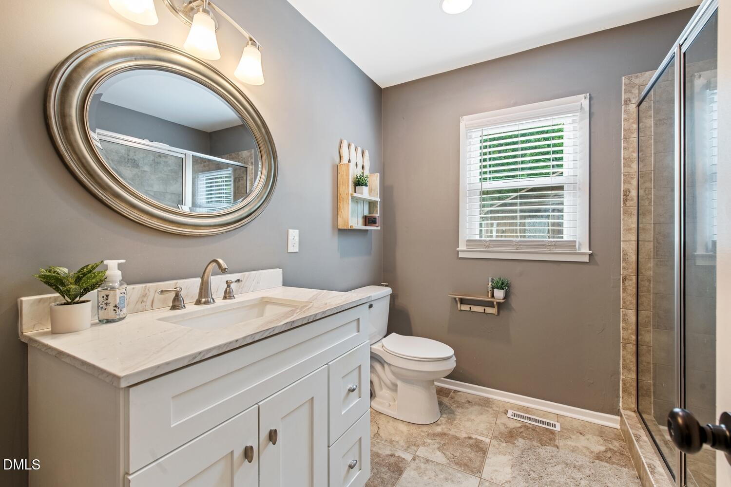 134 Longview Road Madison, NC 27025 - Photo 29 of 49 a bathroom with a sink a toilet and a mirror