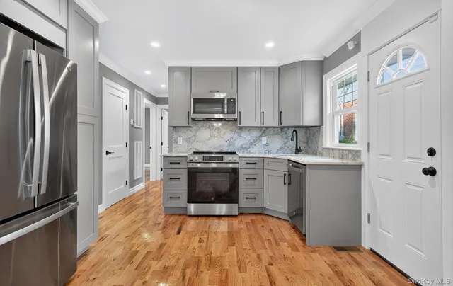 a kitchen with stainless steel appliances granite countertop a refrigerator sink and stove